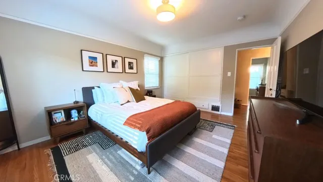 a bedroom with a bed and a flat screen tv