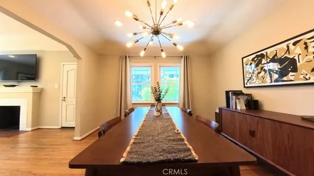 a view of an entryway and a fireplace with wooden floor
