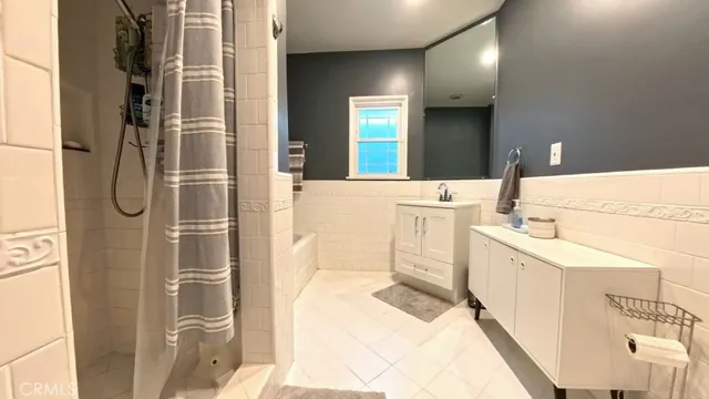 a bathroom with a sink a mirror and a shower