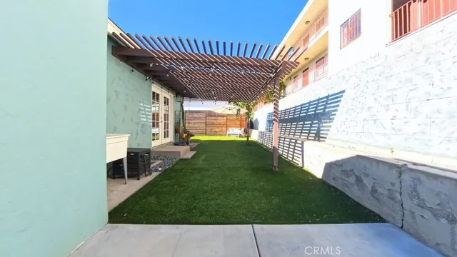 a backyard of a house with table and chairs