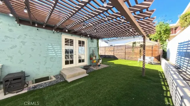 a view of a porch with furniture and a yard