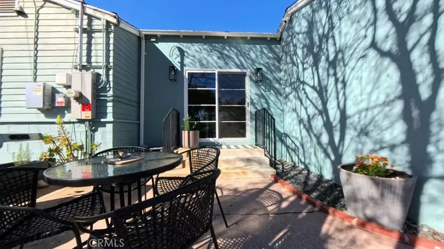 a view of a patio with table and chairs and potted plants