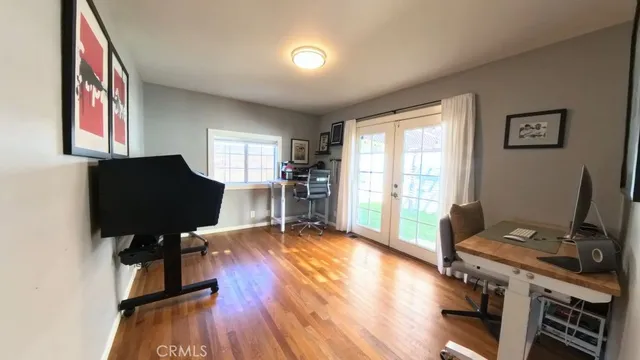 a view of a workspace with furniture and a window