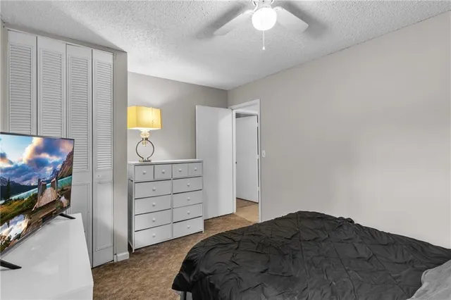 a bedroom with a bed and a television