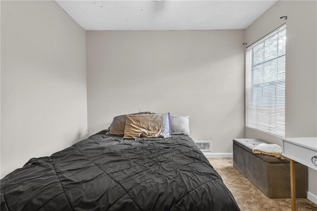 393 Cedar Trace Southwest Marietta, GA 30008 - Photo 13 of 33 a bedroom with a bed and wooden floor