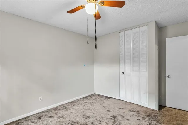 a view of a livingroom with a chandelier fan