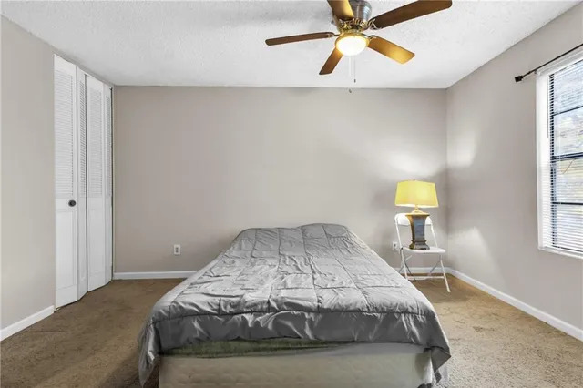 a bedroom with a bed and window