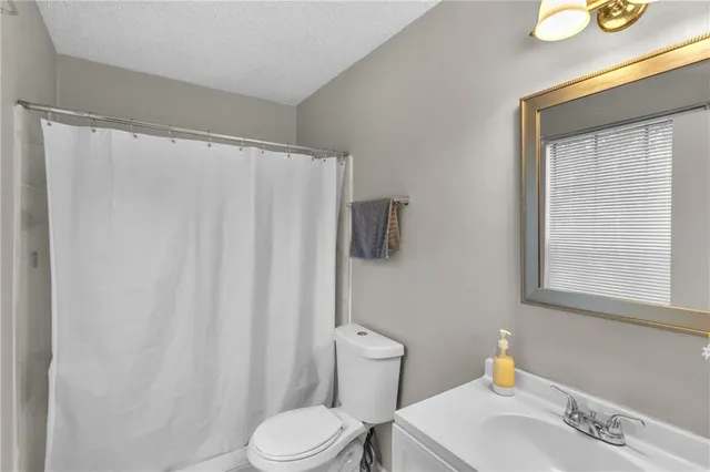a white toilet sitting next to a bathroom sink