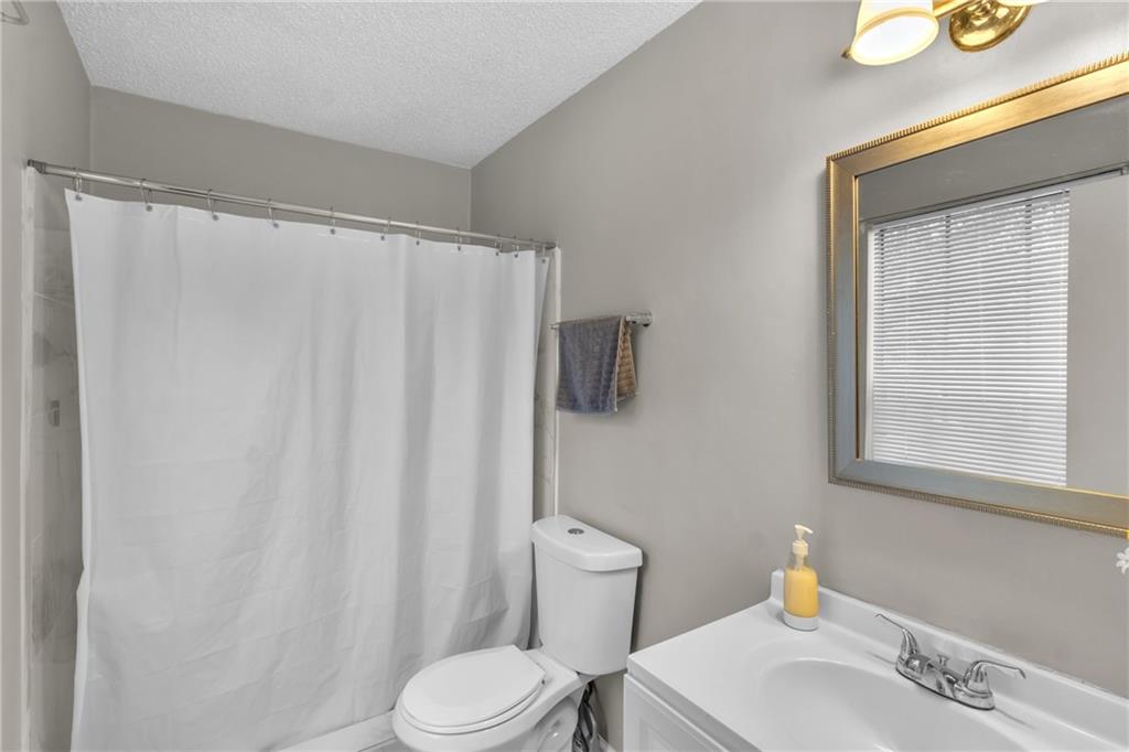 393 Cedar Trace Southwest Marietta, GA 30008 - Photo 20 of 33 a white toilet sitting next to a bathroom sink