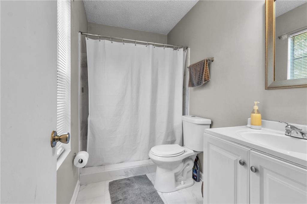 393 Cedar Trace Southwest Marietta, GA 30008 - Photo 21 of 33 a bathroom with a sink toilet and shower