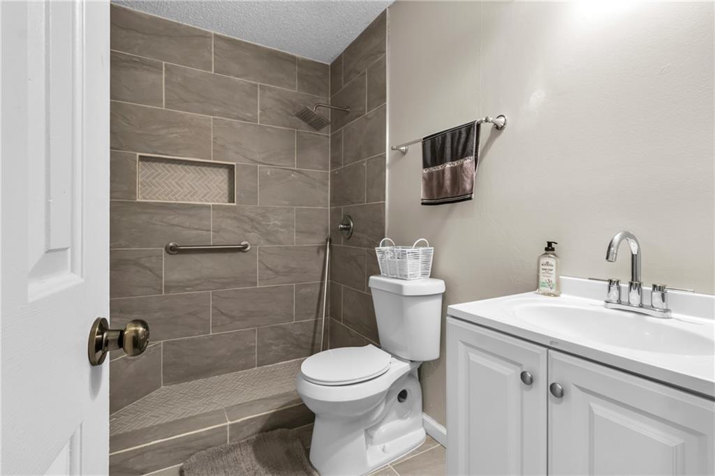 393 Cedar Trace Southwest Marietta, GA 30008 - Photo 22 of 33 a bathroom with a toilet sink and shower