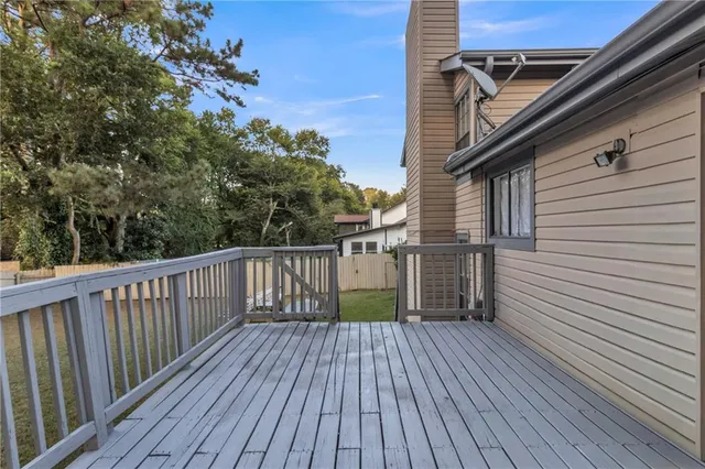 a view of deck with wooden floor and fence