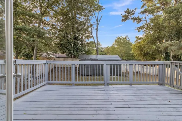a view of balcony with wooden floor and fence