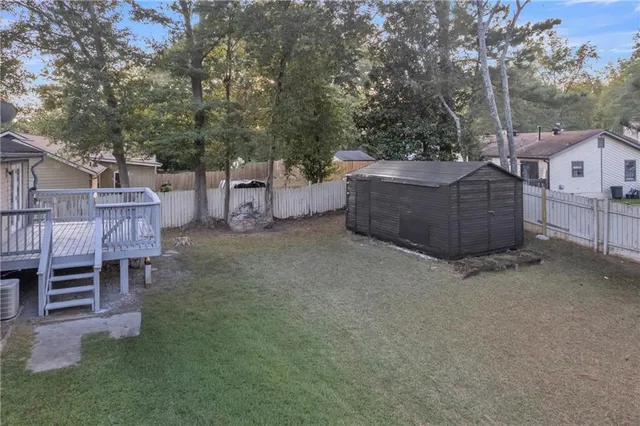 a view of a chairs and table in the back yard of the house