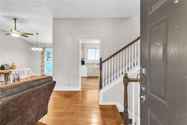 a view of entryway and hall with wooden floor