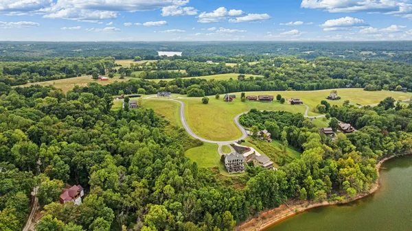 an aerial view of a residential houses with a swimming pool