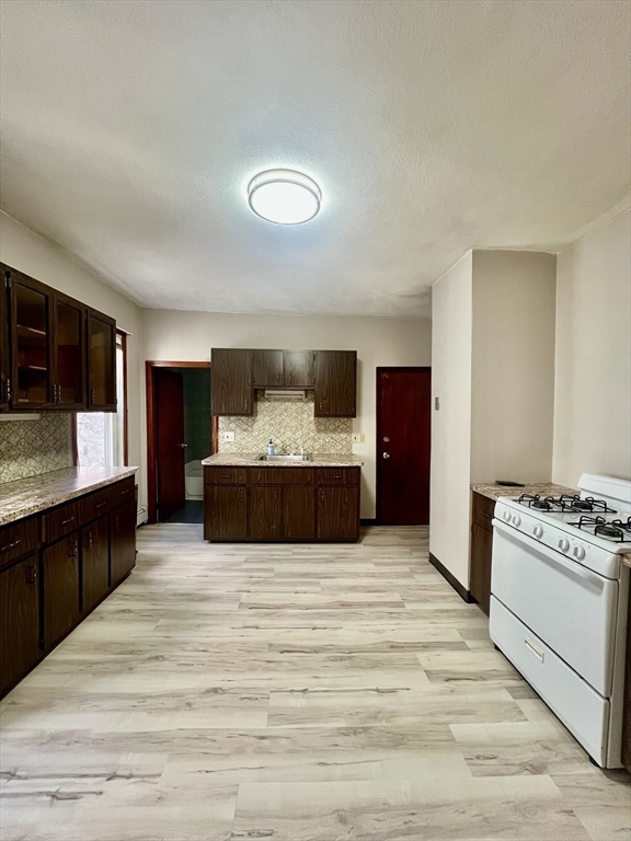 417-419 Ferry Street, Unit 2 Everett, MA 02149 - Photo 19 of 23 a large bedroom with a bed and a flat screen tv