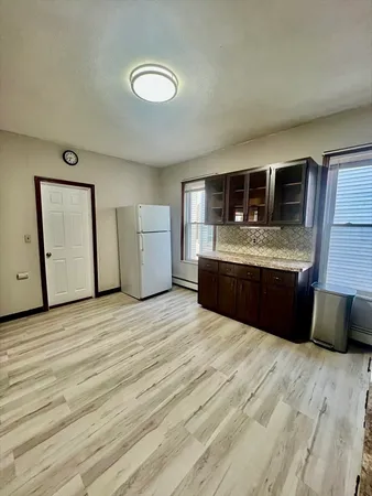 a kitchen with stainless steel appliances granite countertop a stove and a wooden floors
