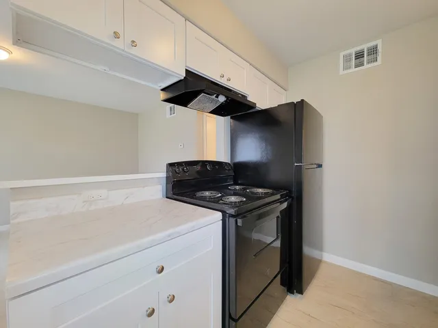 a kitchen with a stove and a microwave