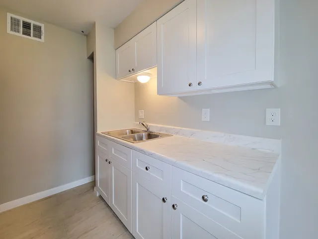 a room with a sink vanity and mirror