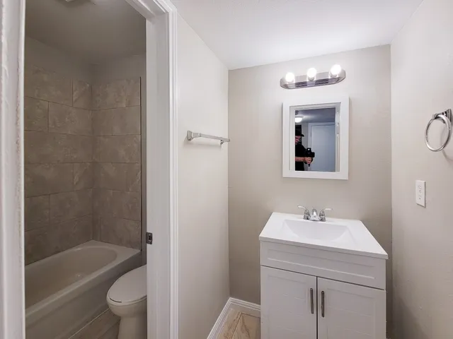 a bathroom with a sink a toilet and bathtub