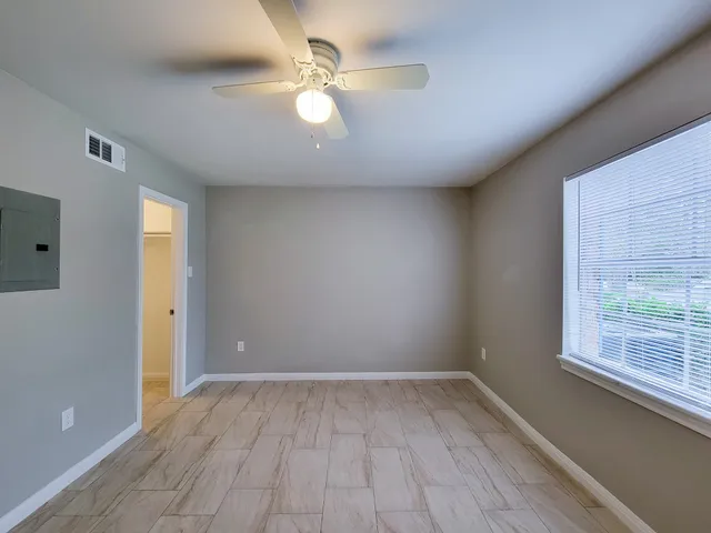 wooden floor in an empty room with a window