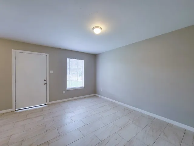 a view of an empty room with a window