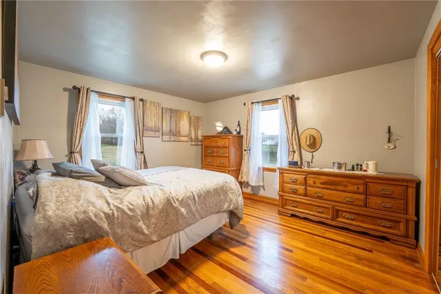 a bedroom with a large bed and windows