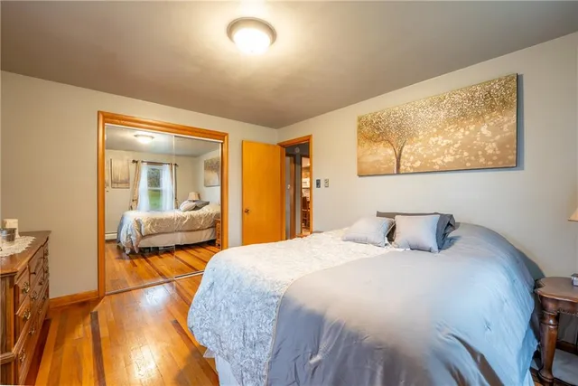 a bedroom with a bed and glass walk in closet