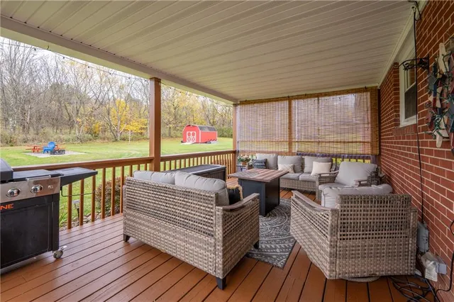 a balcony with furniture and wooden floor