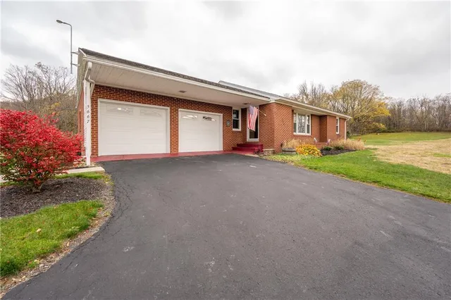 a view of a house with a yard and garage