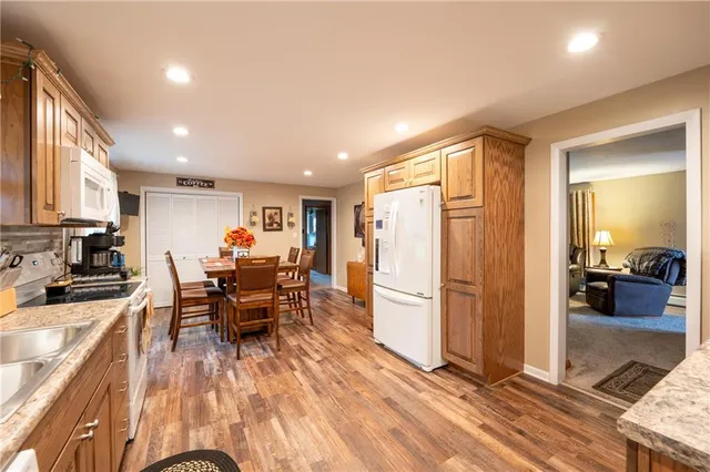 a view of a kitchen with dining room and wooden floor