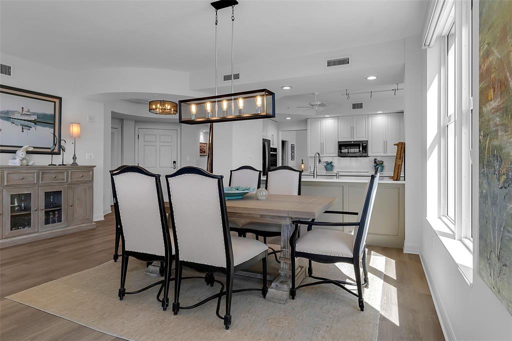 393 North Point Road, Unit 401 Osprey, FL 34229 - Photo 8 of 62 a view of a a dining room with furniture window and wooden floor