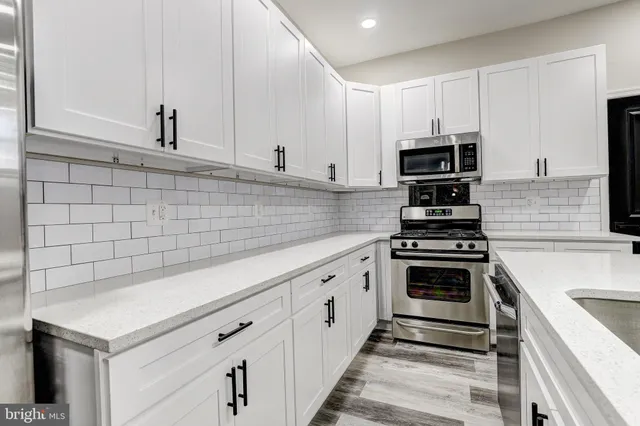 a kitchen with cabinets and appliances