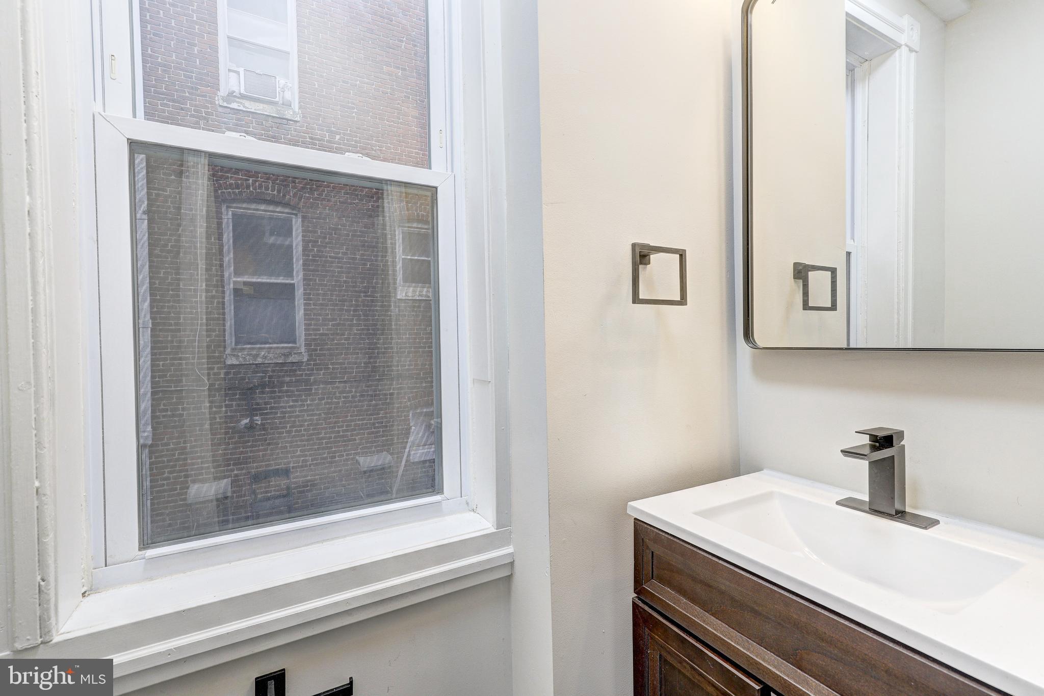 428 South Augusta Avenue Baltimore, MD 21229 - Photo 13 of 28 a bathroom with a sink and a mirror