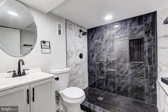 a bathroom with a sink toilet and shower