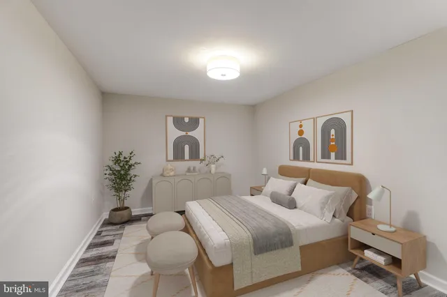 a bedroom with a bed and a potted plant