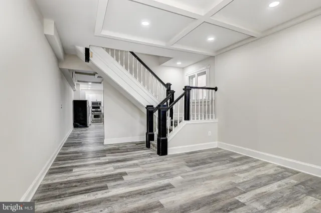 a view of entryway and hall with wooden floor