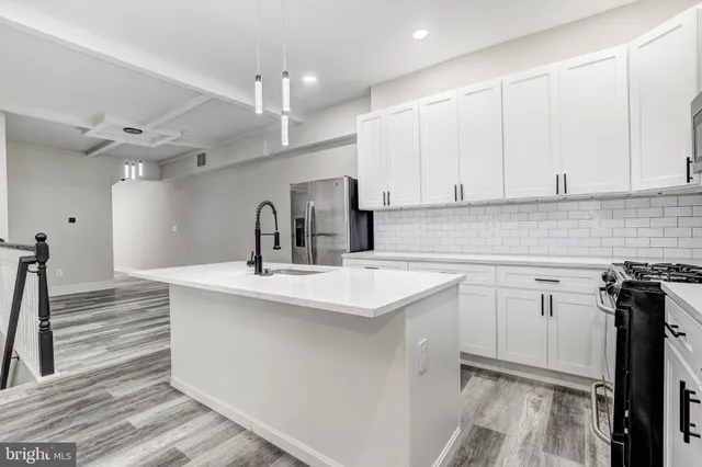 a kitchen with a sink cabinets and window