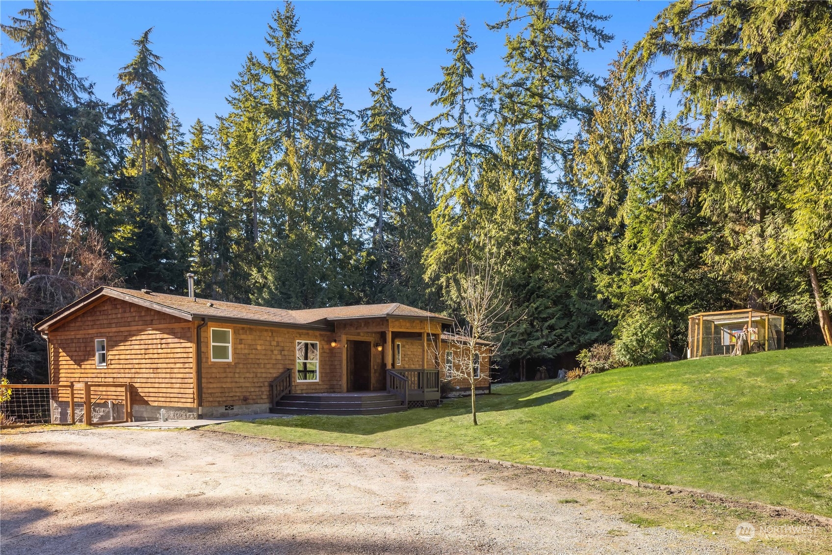 11325 Southwest Cove Road Vashon, WA 98070 - Photo 1 of 1 a view of a house with a large tree in front of a house