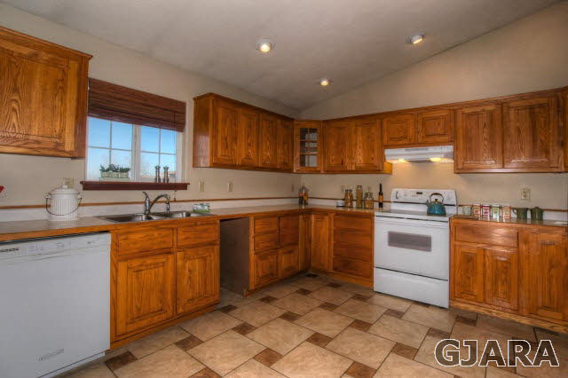 1321 17 Road Fruita, CO 81521 - Photo 7 of 26 a kitchen with granite countertop a sink stove top oven and cabinets