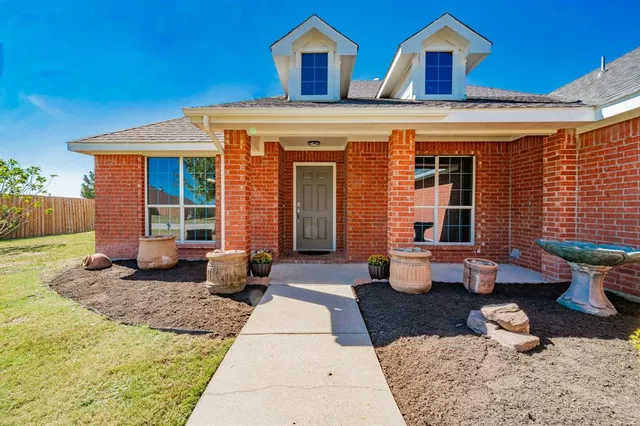 a front view of a house with outdoor seating