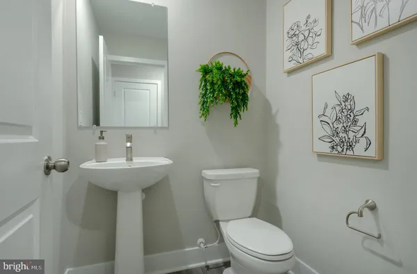 a white toilet sitting next to a bathroom sink