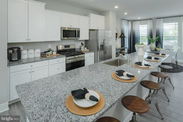a kitchen with furniture and a refrigerator