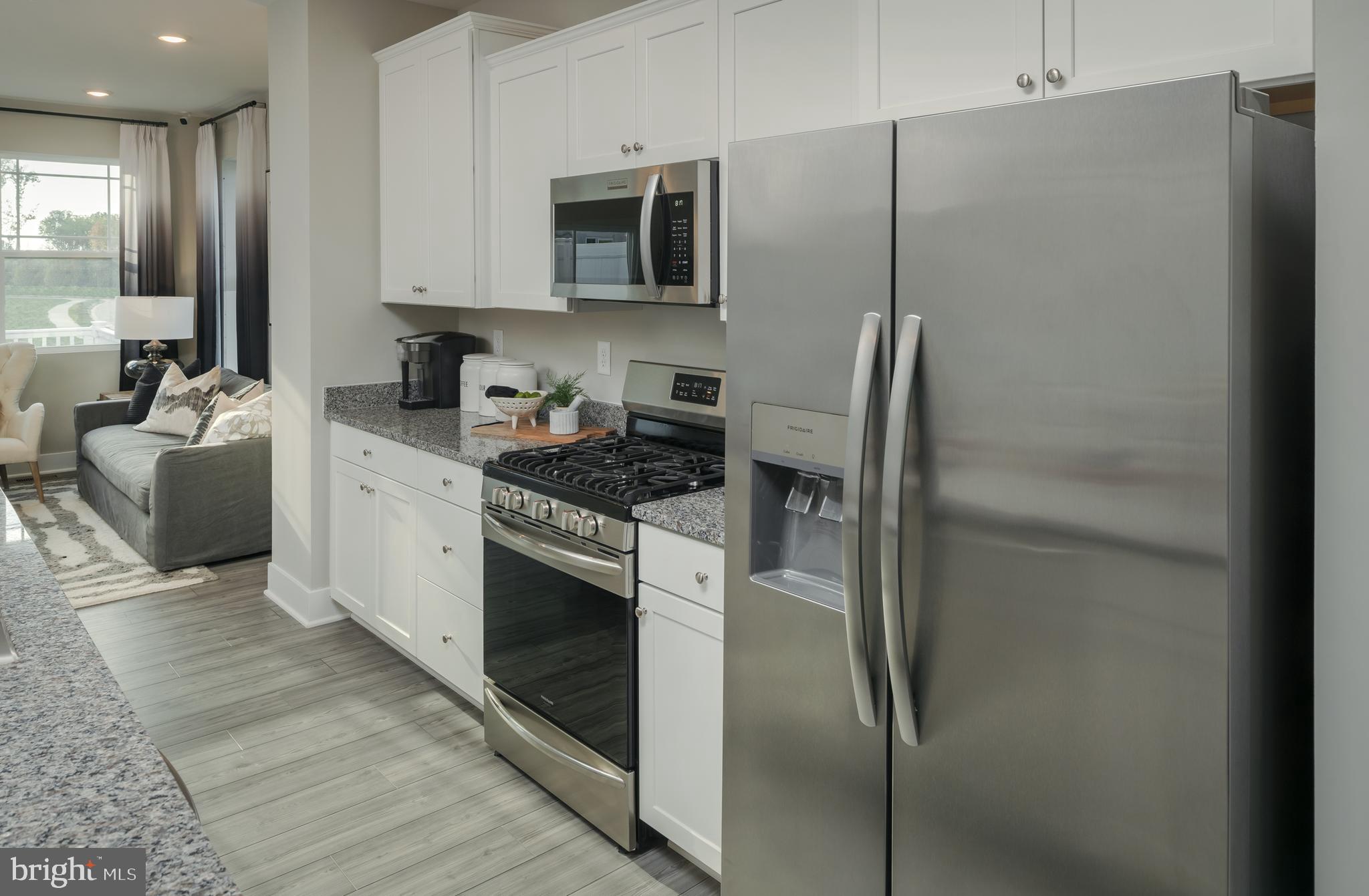 1801 Betterton Road Essex, MD 21221 - Photo 7 of 34 a kitchen with stainless steel appliances granite countertop a refrigerator a stove and a sink