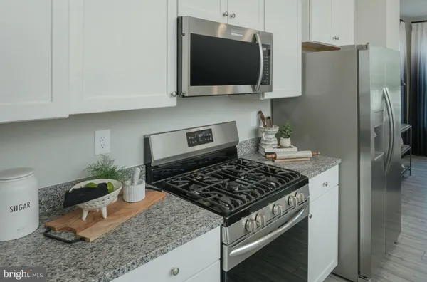 a kitchen with a stove and a microwave