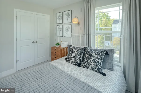 a bed sitting in a bedroom next to a window