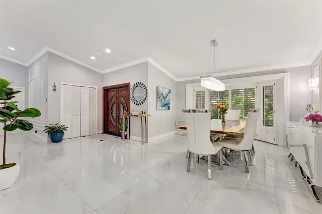 a kitchen with stainless steel appliances kitchen island granite countertop a refrigerator and a sink