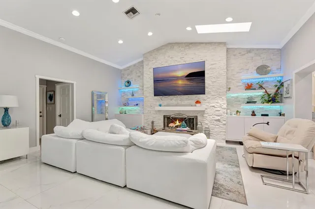a view of a livingroom with couch and floor to ceiling window