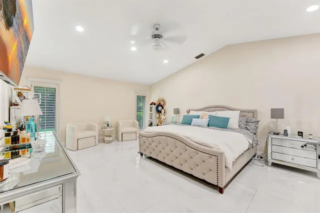 a spacious bedroom with a bed and a window